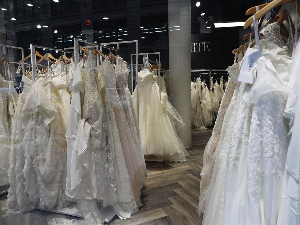 Racks of wedding dresses hang inside David's Bridal store