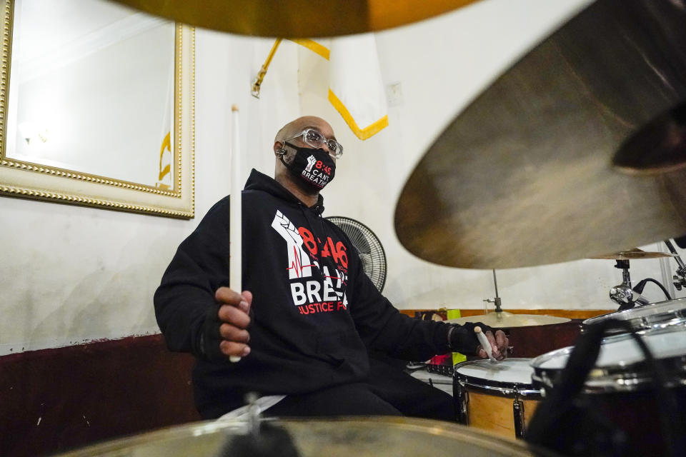 Terrence Floyd, brother of George Floyd, plays the drums with other artists during a recording session for an album of protest songs with the Rev. Kevin McCall Monday, Dec. 28, 2020, in New York. A full album of songs is set for release in May, one year after George Floyd’s death at the hands of police in Minneapolis. Billed as the first album of its kind, the project follows a long history of racial justice messages and protest slogans crossing over into popular music and culture. (AP Photo/Frank Franklin II)