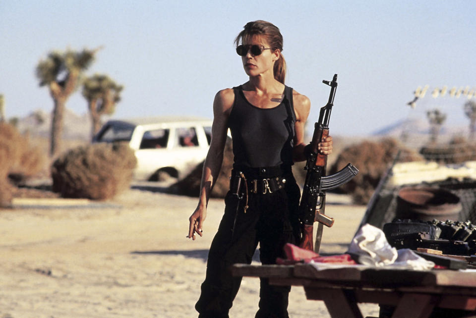 Linda Hamilton holding a gun.