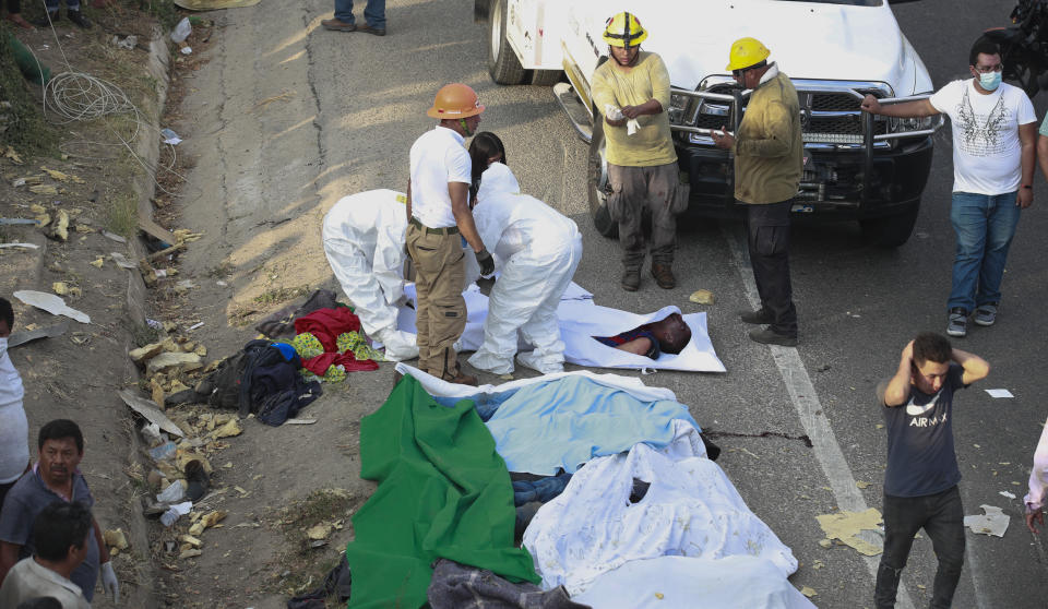 Bodies in bodybags are placed on the side of the road after an accident in Tuxtla Gutierrez, Chiapas state, Mexico, Thursday, Dec. 9, 2021. Mexican authorities say at least 49 people were killed and dozens more injured when a cargo truck carrying Central American migrants rolled over on a highway in southern Mexico. (AP Photo)