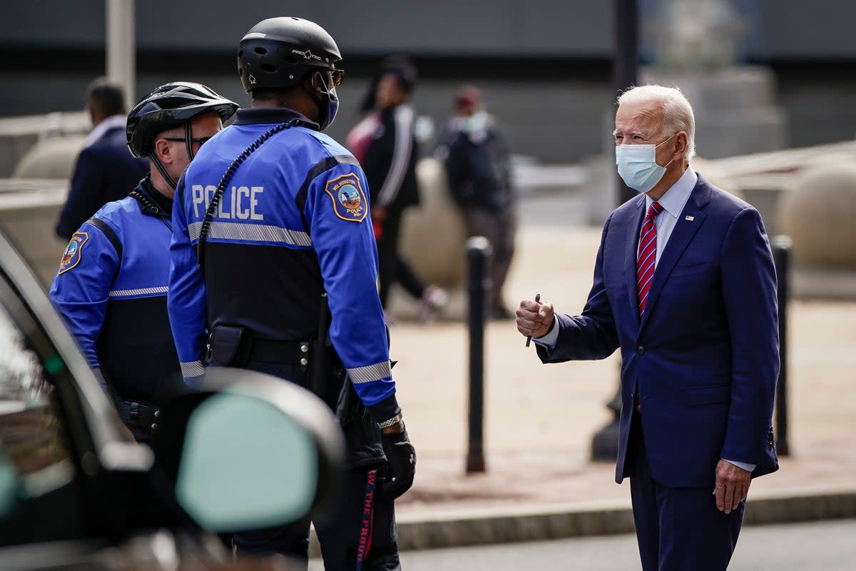 Joe Biden greets police officers as he departs The Queen theater on October 19, 2020 in Wilmington, Delaware (Getty Images)