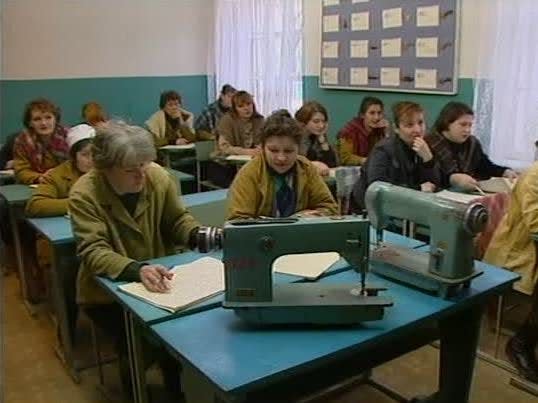 Russian prisoners work on sewing machines.