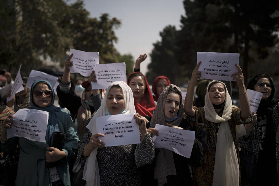 Afghan women march to demand their rights under the Taliban rule during a demonstration near the former Women's Affairs Ministry building in Kabul, Afghanistan, Sunday, Sept. 19, 2021. The interim mayor of Afghanistan’s capital said Sunday that many female city employees have been ordered to stay home by the country’s new Taliban rulers. (AP Photo)