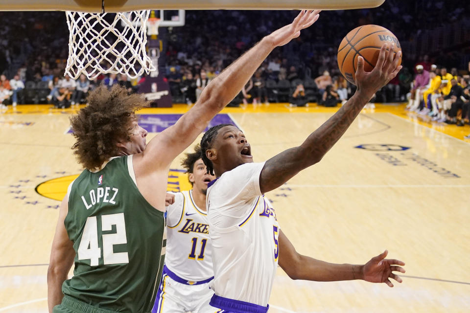 Los Angeles Lakers forward Cam Reddish, right, shoots as Milwaukee Bucks center Robin Lopez defends during the first half of an NBA preseason basketball game Sunday, Oct. 15, 2023, in Los Angeles. (AP Photo/Mark J. Terrill)