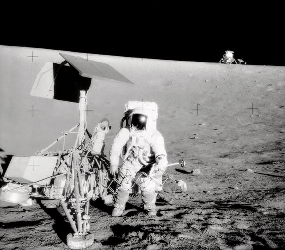 The Apollo 12 Commander examines the unmanned Surveyor III spacecraft during the second extravehicular activity in 1969.