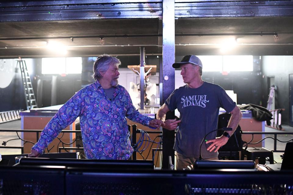 Scott West, left, talks with sound and light technician Eric Nowinski while testing out the stage production at Asylum 801, a new West-family nightclub opening April 4 at the former International music venue. Known casually as The Asylum, the club rivals The Mill & Mine in size and will feature DJs every Thursday through Saturday.