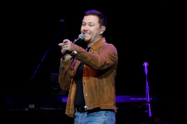 <p>Jason Kempin/Getty</p> Scotty McCreery performs in Nashville in October 2023