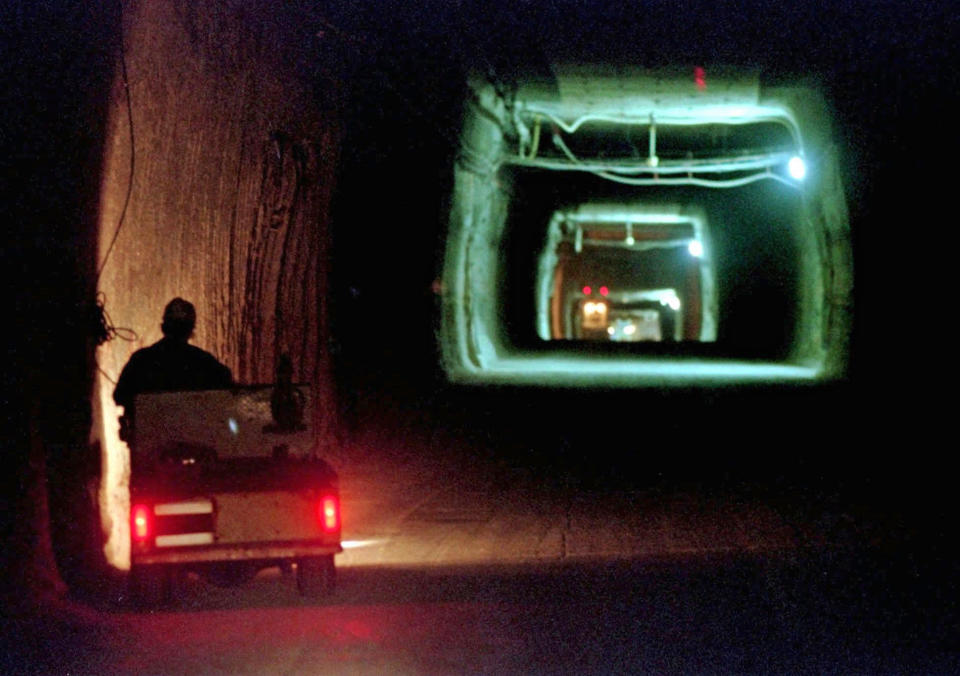 FILE - A worker drives a cart through a tunnel inside the Waste Isolation Pilot Plant No. 2, 150-feet below the surface near Carlsbad, N.M., on April 8, 1998. On Thursday, Dec. 8, 2022, New Mexico officials outlined new conditions for a proposed permit for the U.S. government to continue disposing of nuclear waste in the southeast corner of the state as part of a multibillion-dollar federal cleanup program. (AP Photo/Eric Draper, File)