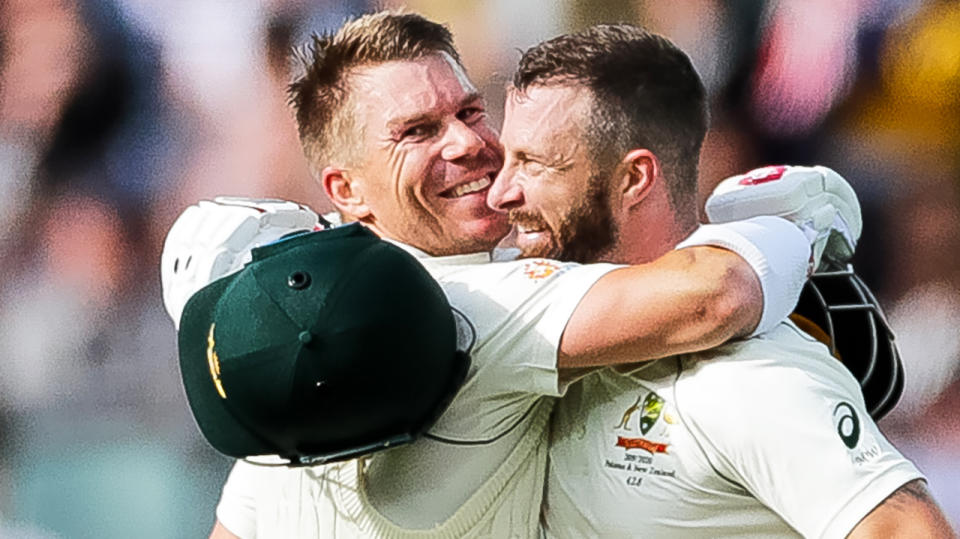 David Warner, pictured left, embraces Matthew Wade during day two of Australia's test against Pakistan in Adelaide.