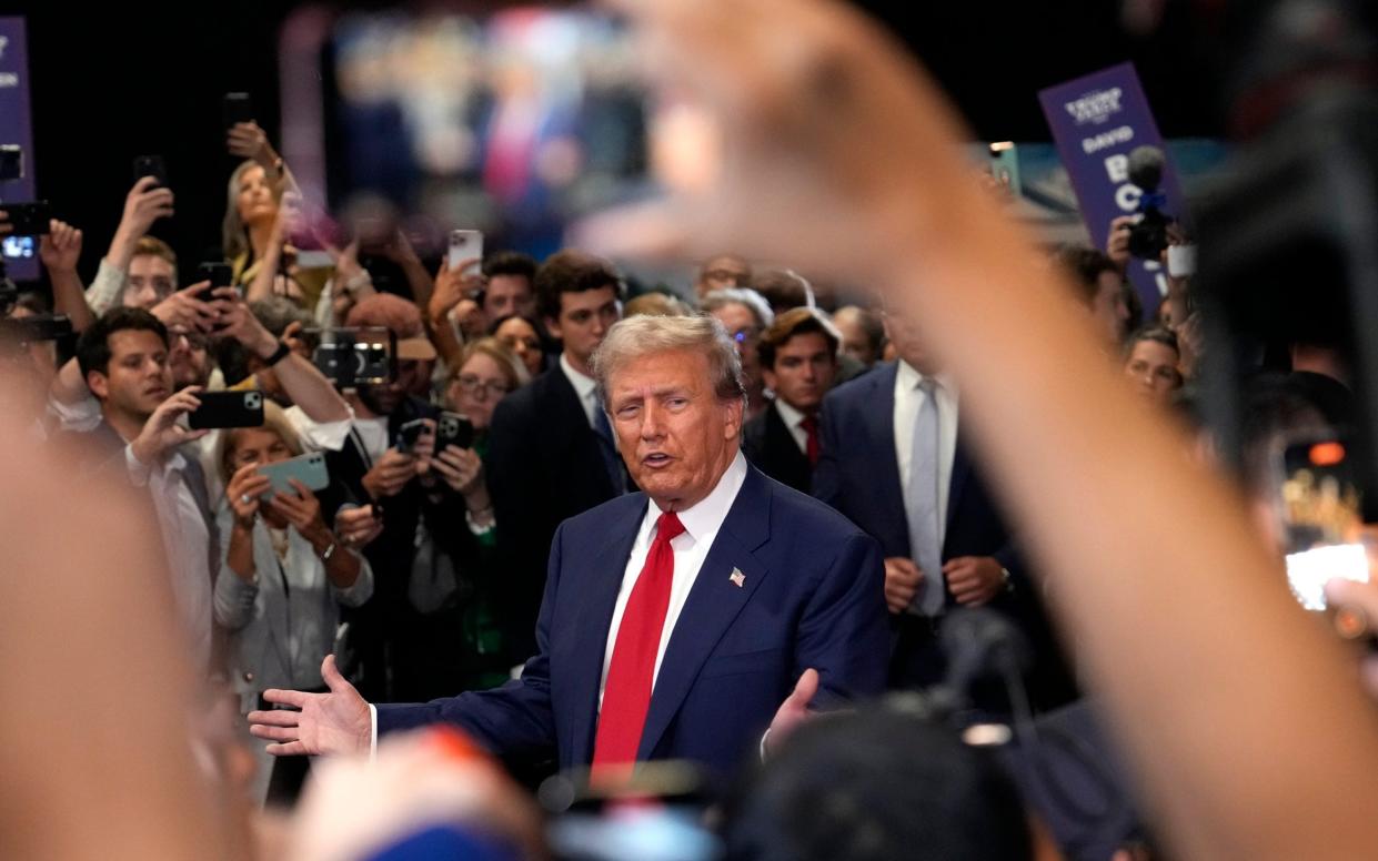 Donald Trump speaks to reporters in the spin room