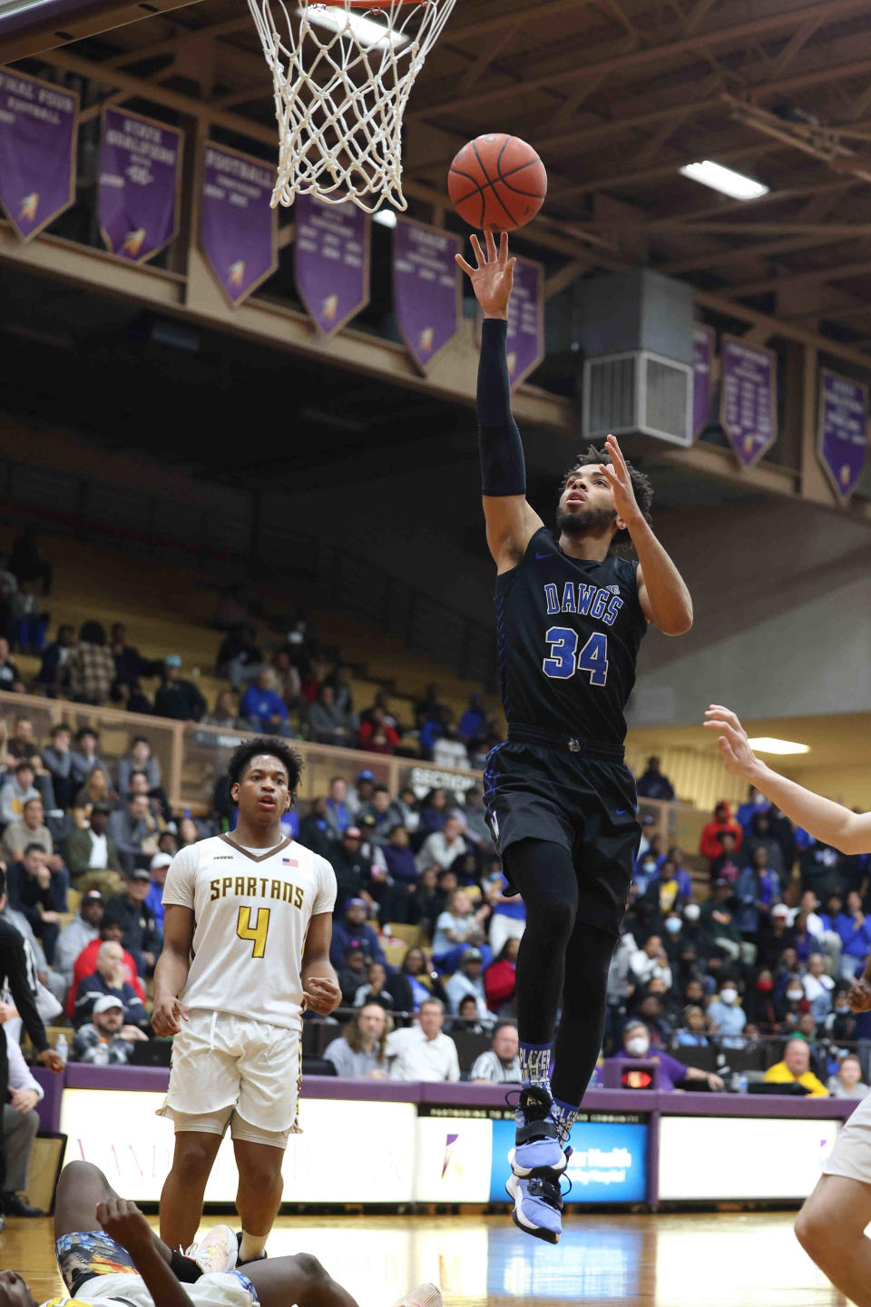 Woodward guard Paul McMillan IV drives to the basket during their win over Roger Bacon, Thursday, March 10, 2022.