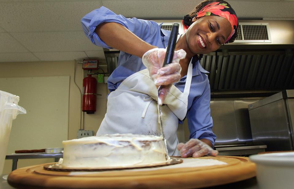 Angela Logan makes her signature homemade apple cakes and muffins, two years after she saved her home from fore closure by selling her cakes door-to-door. She now has a business based in Hawthorne, and a website maccakes.com. Here she is putting a first coat of icing on cakes, July 2011.