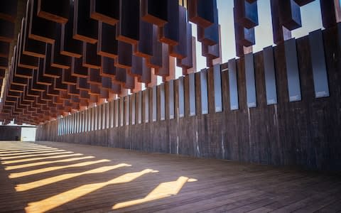 800 weathered steel columns, each one etched with the names of a lynching victim, hang from the roof of the - Credit: Audra Melton/The New York Times