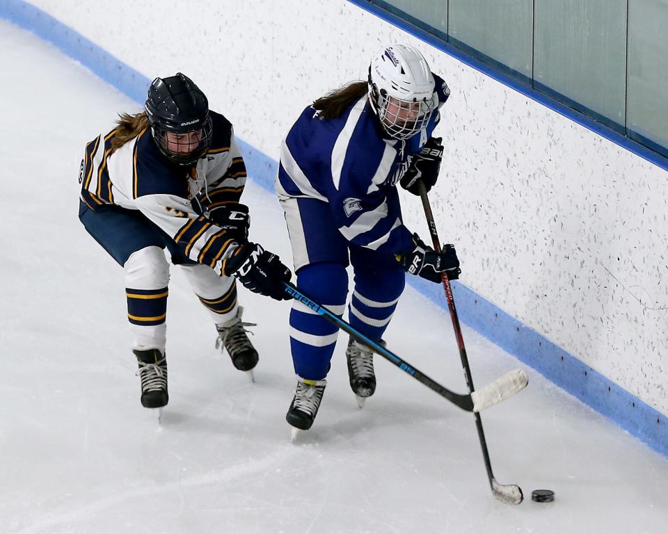 Scituate's Kiera Modder looks to control the puck while Hanover's Callie Baldwin tries to get back on defense during first period action of their game against Scituate at Hobomock Ice Arena in Pembroke on Wednesday, Feb. 23, 2022. 