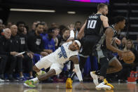 Sacramento Kings guard Malik Monk, right, uses a screen set by forward Domantas Sabonis (10) to break away from Orlando Magic guard Gary Harris (14) in the first quarter in an NBA basketball game in Sacramento, Calif., Monday, Jan. 9, 2023. (AP Photo/José Luis Villegas)