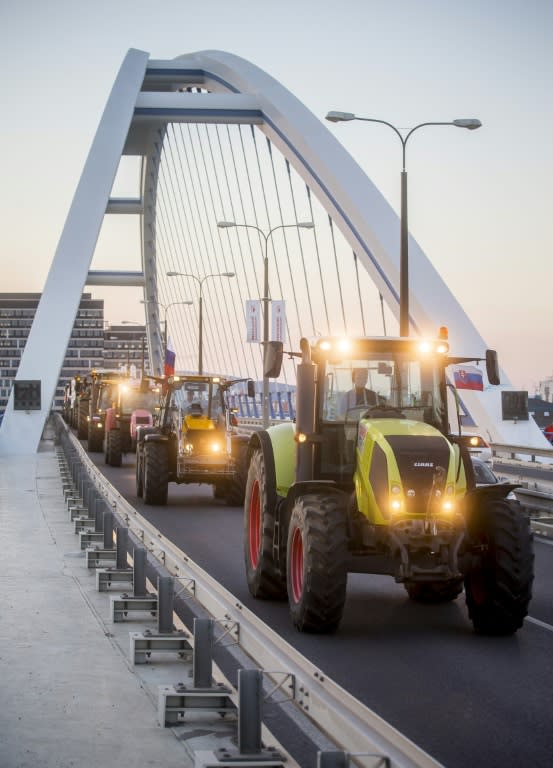 Slovak farmers on their tractors travel across a bridge towards Bratislava, where they will continue their protest on Wednesday