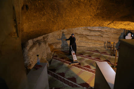 An employee of the Jordanian Waqf, or Islamic trust, that oversees the area, cleans during preparations ahead of the Muslim holy month of Ramadan, in the Dome of the Rock located on the compound known to Muslims as al-Haram al-Sharif and to Jews as Temple Mount, in Jerusalem's Old City, April 19, 2017. REUTERS/Ammar Awad