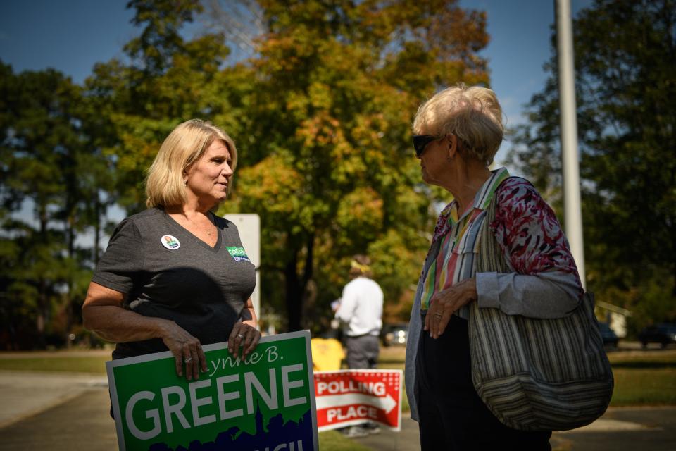 City Council District 5 candidate Lynne Greene speaks to a voter before she goes into Glendale Acres Elementary School to vote on Tuesday, Oct. 10, 2023.