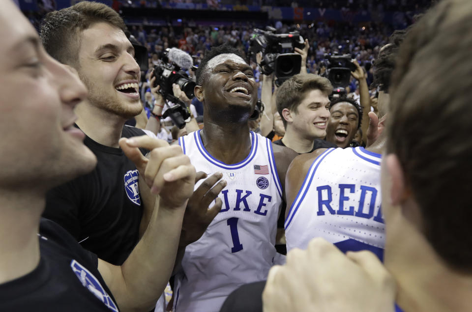 Duke's Zion Williamson (1) celebrates with teammates after Duke defeated Florida State in the NCAA college basketball championship game of the Atlantic Coast Conference tournament in Charlotte, N.C., Saturday, March 16, 2019. (AP Photo/Chuck Burton)