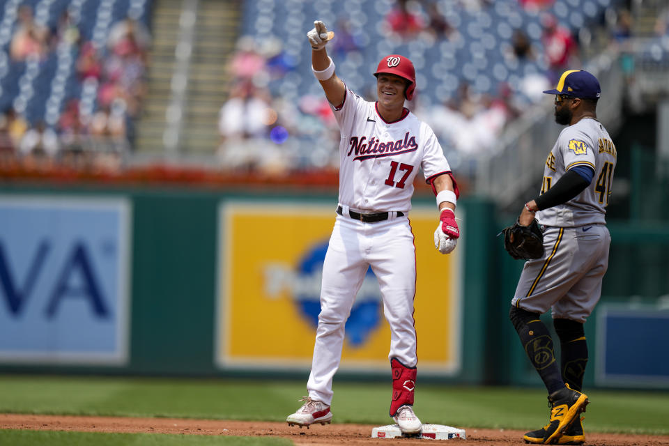 Washington Nationals' Alex Call (17) celebrates his double as Milwaukee Brewers first baseman Carlos Santana looks on, at right, during the third inning of a baseball game at Nationals Park, Wednesday, Aug. 2, 2023, in Washington. (AP Photo/Alex Brandon)