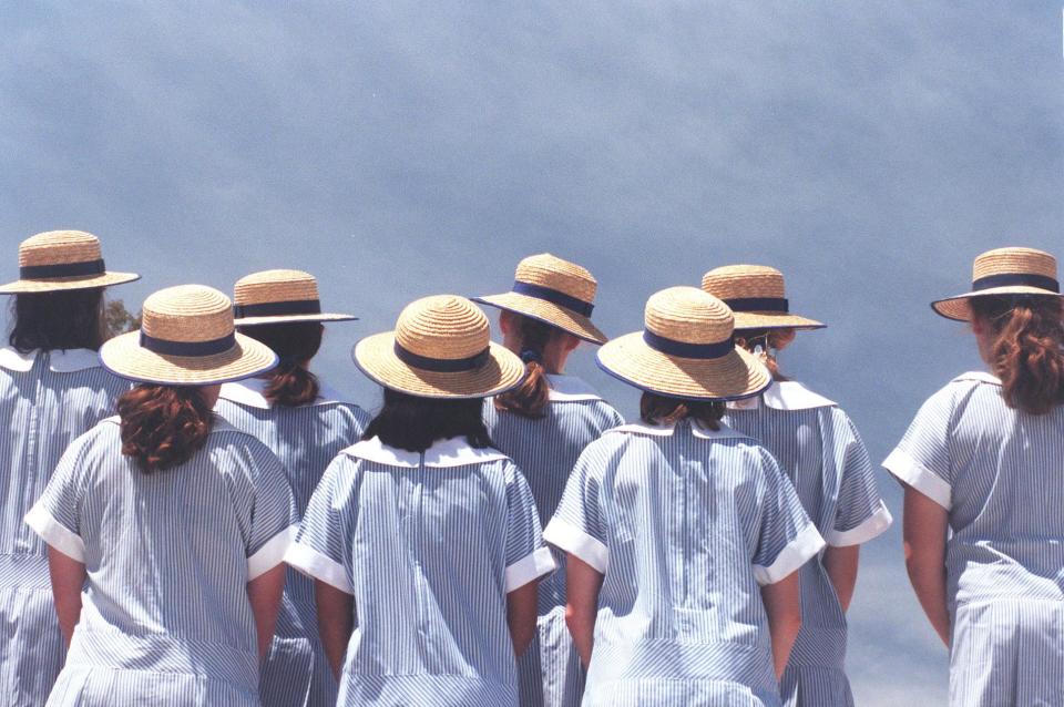 A group of girls from a private education high school looking away from the camera.