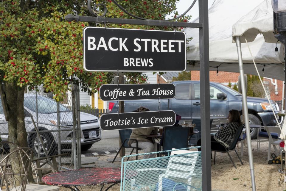 If you're looking for common ground in America these days, think coffee grounds. In Lovettsville, Va., a politically polarized town, where Republicans, Democrats and the non-aligned converge at Back Street Brews, seen on Dec. 24, 2021. At the café, civility is served with the cappuccino and people are just neighbors. Almost a year after the Jan. 6 Capitol insurrection, it's clear that there is a warring America – loud, coarse, power hungry — and a quieter one of neighbors, social ties and face-to-face community. (AP Photo/Cal Woodward)