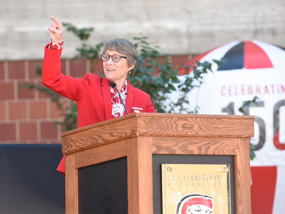 St. Cloud State University President Robbyn Wacker points to cheering alumni at the dedication of Husky Plaza Saturday, Sept. 28, 2019.