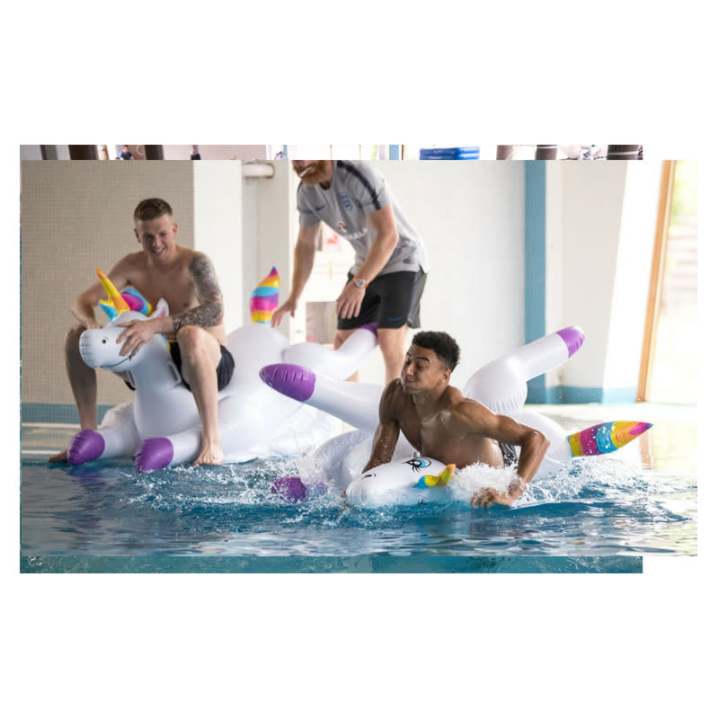 Jesse Lingard and Jordan Pickford play with inflatable unicorns in the pool during a recovery session at the ForRestMix Hotel in Repino (REX)