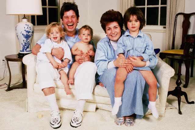 <p>Dave Hogan/Getty </p> Ozzy Osbourne and Sharon Osbourne with kids Kelly, Jack and Aimee in the early 1990s