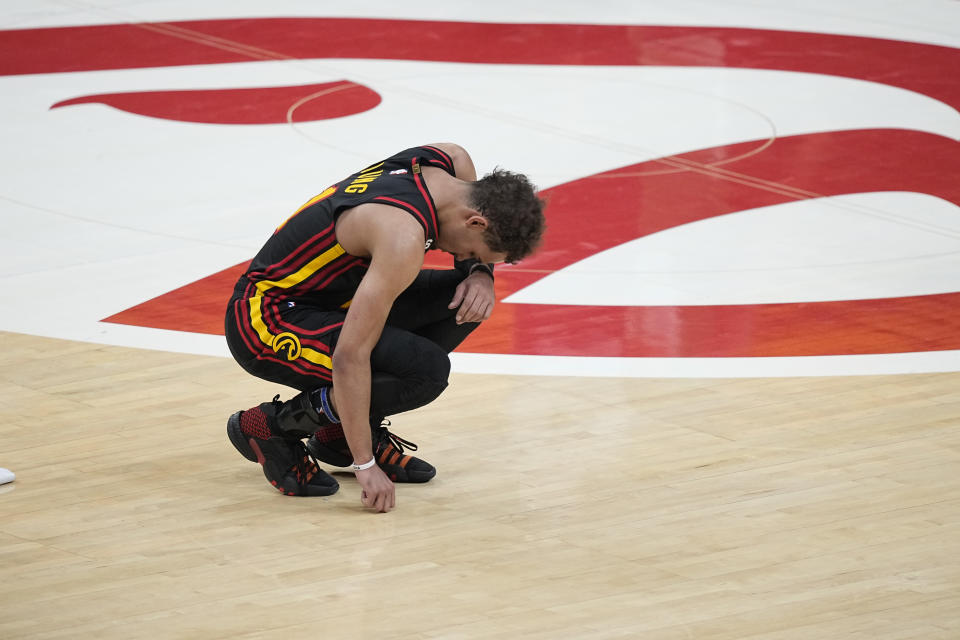 Atlanta Hawks guard Trae Young (11) kneels near the end of the second half of Game 6 of a first-round NBA basketball playoff series against Boston Celtics, Thursday, April 27, 2023, in Atlanta. (AP Photo/Brynn Anderson)