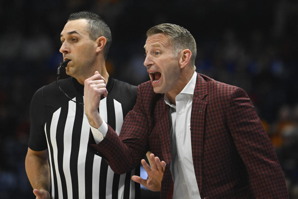 Alabama coach Nate Oats gets tangled with a referee while shouting to players during the first half of an NCAA college basketball game against Mississippi State in the third round of the Southeastern Conference tournament, Friday, March 10, 2023, in Nashville, Tenn. (AP Photo/John Amis)