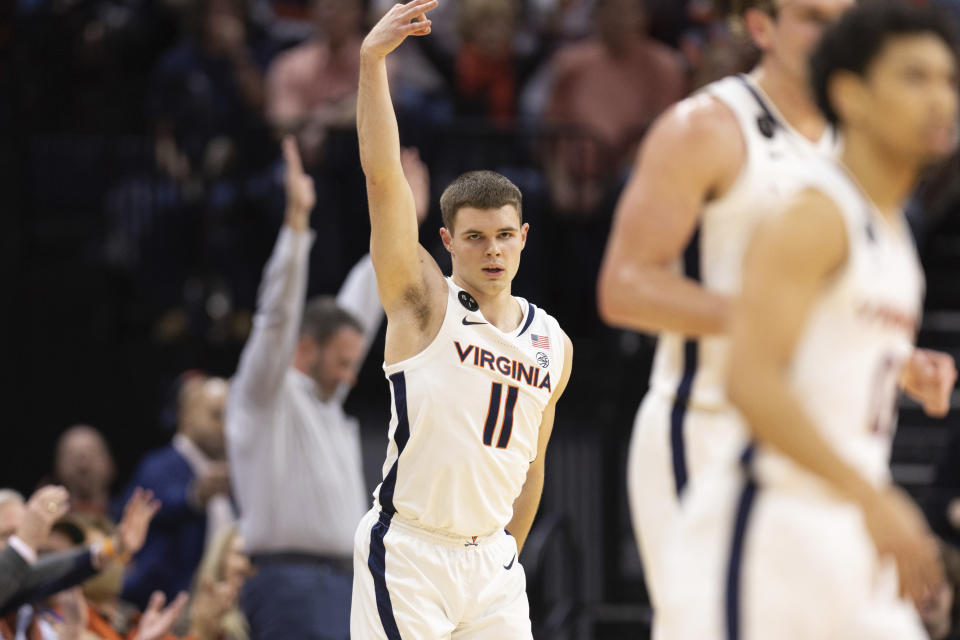 Virginia's Isaac McKneely (11) celebrates during the first half of an NCAA college basketball game against Syracuse in Charlottesville, Va., Saturday, Jan. 7, 2023. (AP Photo/Mike Kropf)