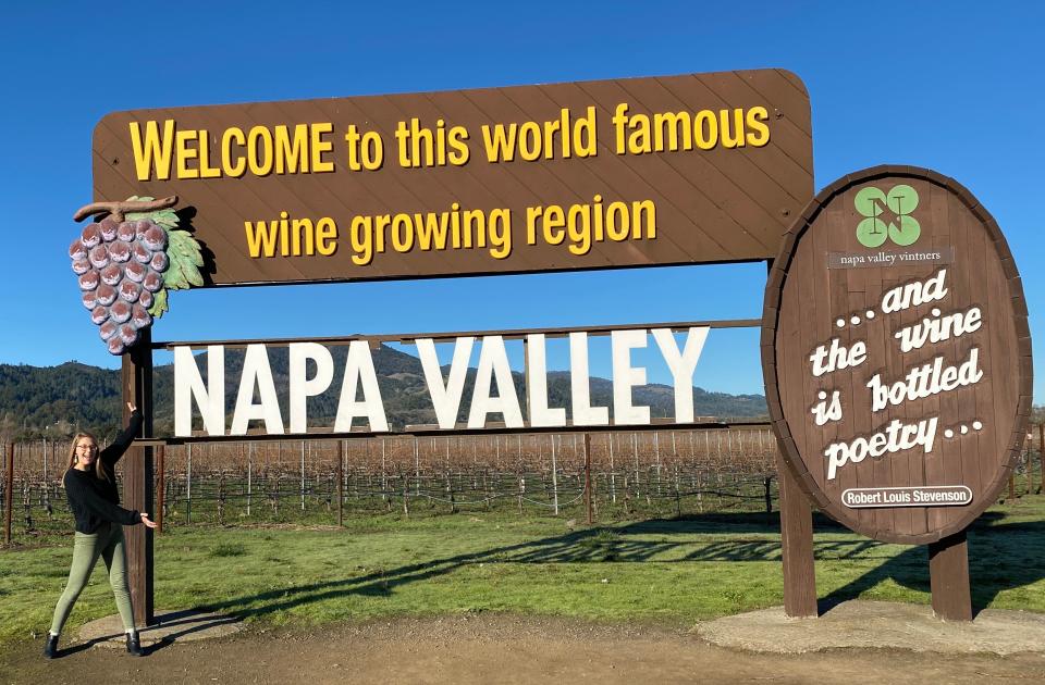 My daughter posing with the NAPA Valley sign