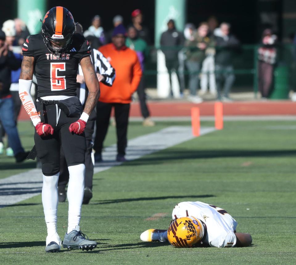 Belleville defender Jalen Johnson makes the hit on Davison receiver Braylen Naves during first-half action at Novi High School on Saturday, Nov. 18, 2023.