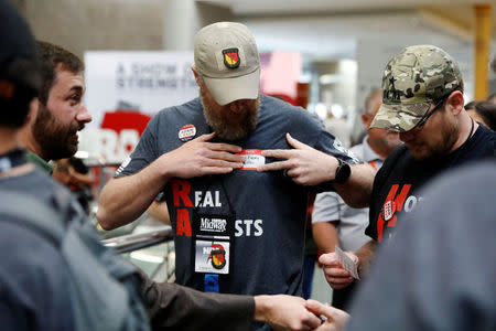 Gun rights proponents Adam Kraut (L) and Tim Harmsen, speak to NRA members about Kraut's candidacy for a seat on the board of the National Rifle Association (NRA) at the organisation's convention in Dallas, Texas, U.S., May 5, 2018. REUTERS/Lucas Jackson