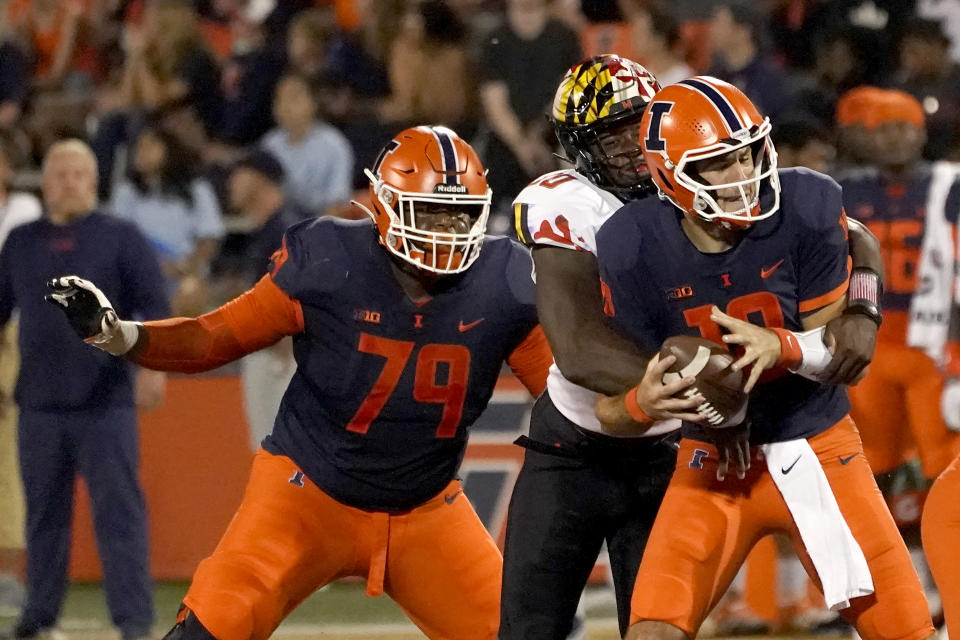 Maryland linebacker Durell Nchami, center, gets by Illinois offensive lineman Vederian Lowe (79) and sacks quarterback Brandon Peters during the first half of an NCAA college football game Friday, Sept. 17, 2021, in Champaign, Ill. (AP Photo/Charles Rex Arbogast)