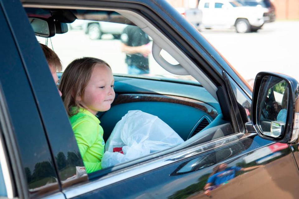 Kace Nezbeth, 4, smiles after receiving a bag of toys from the Christian Appalachian Project a giveaway at Lawrence County High School in Louisa, Ky., Thursday, June 24, 2021.