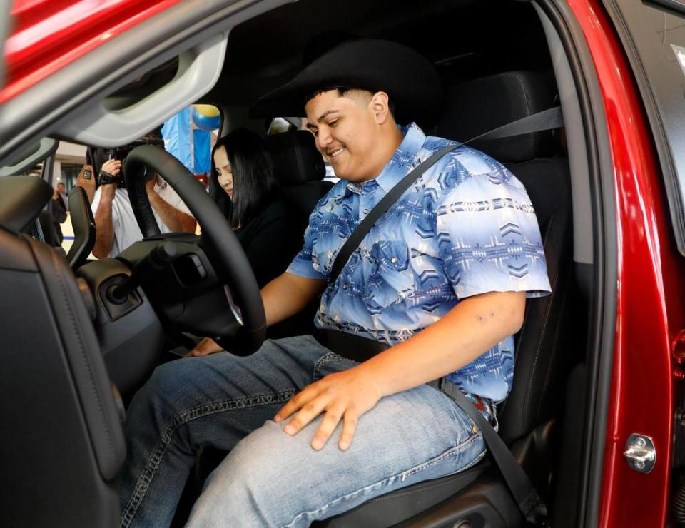 With his mother, Elvia, as a passenger, Riley Leon, 16, checks out his new Silverado at Bruce Lowrie Chevrolet in Fort Worth, Texas, Saturday, March 26, 2022. Leon received a new Chevrolet Silverado after the one he was driving was totaled in a tornado.