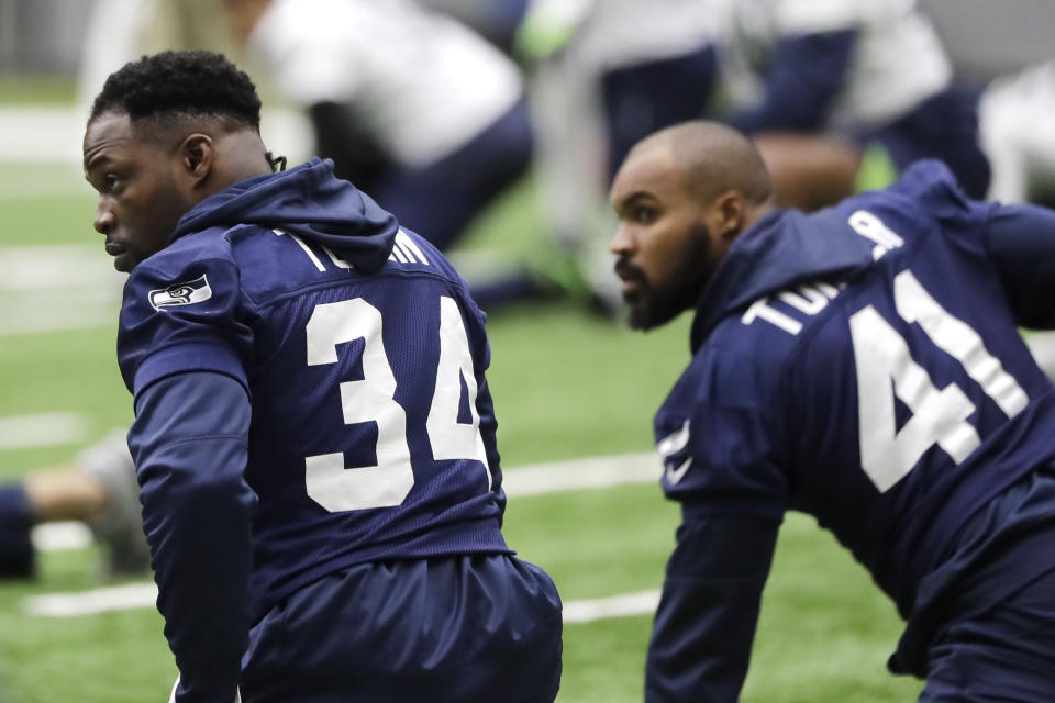 Seattle Seahawks running back Robert Turbin, left, stretches next to practice squad running back Xavier Turner, right, before NFL football practice, Friday, Dec. 27, 2019, in Renton, Wash. (AP Photo/Ted S. Warren)