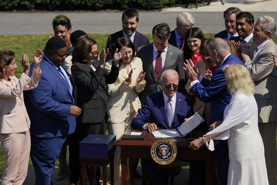 President Joe Biden is applauded after signing into law the CHIPS and Science Act of 2022.