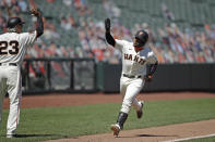 San Francisco Giants' Chadwick Tromp, right, waves at third base coach Ron Wotus (23) after hitting a two run home run against the Texas Rangers in the sixth inning of a baseball game Sunday, Aug. 2, 2020, in San Francisco. (AP Photo/Ben Margot)