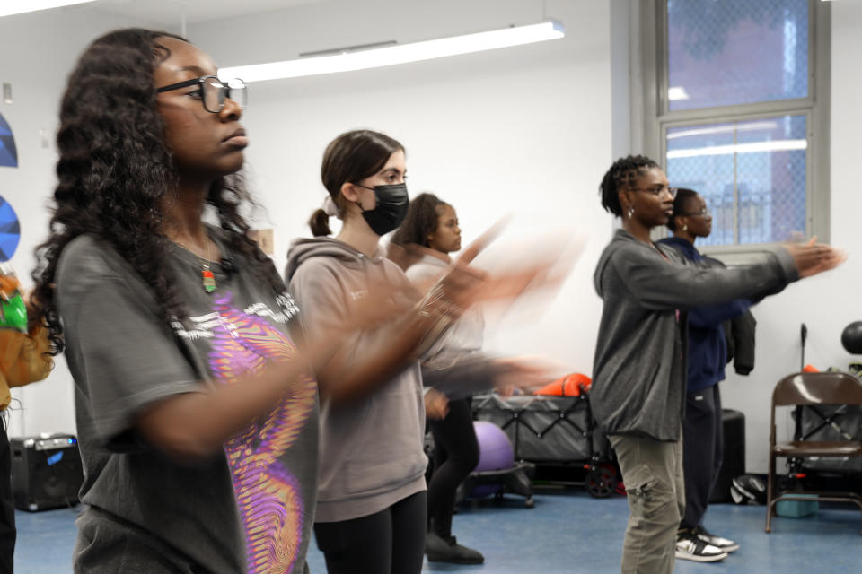 Hillary Amofa, left, practices with members of the Lincoln Park High School step team after school Friday, March 8, 2024, in Chicago. When she started writing her college essay, Amofa told the story she thought admissions offices wanted to hear. She wrote about being the daughter of immigrants from Ghana, about growing up in a small apartment in Chicago. She described hardship and struggle. Then she deleted it all. "I would just find myself kind of trauma-dumping," said the 18 year-old senior, "And I'm just like, this doesn't really say anything about me as a person." (AP Photo/Charles Rex Arbogast)