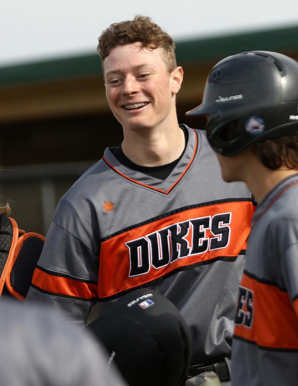 Marlington batter Josh Dezenzo surrounded by teammates following his first inning, three-run home run against Youngstown Chaney during tournament play at Marlington High School Monday, May 17, 2021.