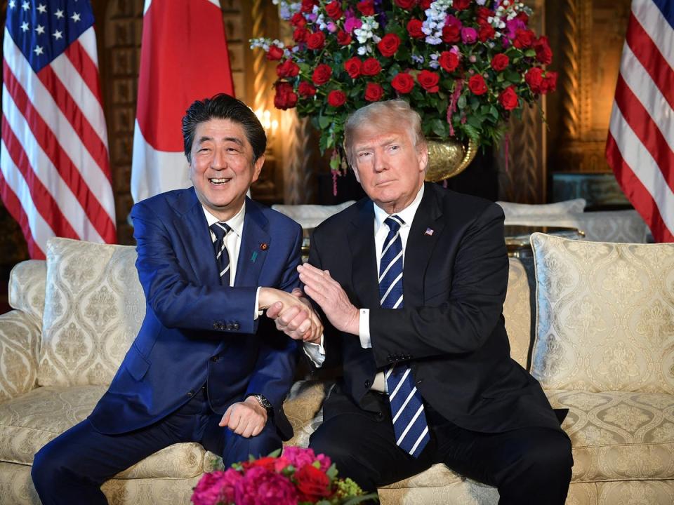 US president Donald Trump greets Abe as he arrives for talks in Palm Beach, Florida, in 2018 (AFP/Getty)