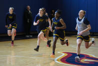 Indiana Fever guard Caitlin Clark, center left, runs sprints with teammates, including Erica Wheeler, center right, as the WNBA basketball team practices in Indianapolis, Sunday, April 28, 2024. (AP Photo/Michael Conroy)