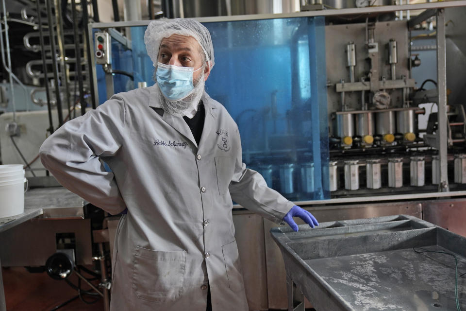 Rabbi Joseph Schwartz supervises the koshering of the production line and instruments used for Hanan Products' kosher-for-passover production run, Thursday, Jan. 7, 2021, in Hicksville, N.Y. (AP Photo/Seth Wenig)