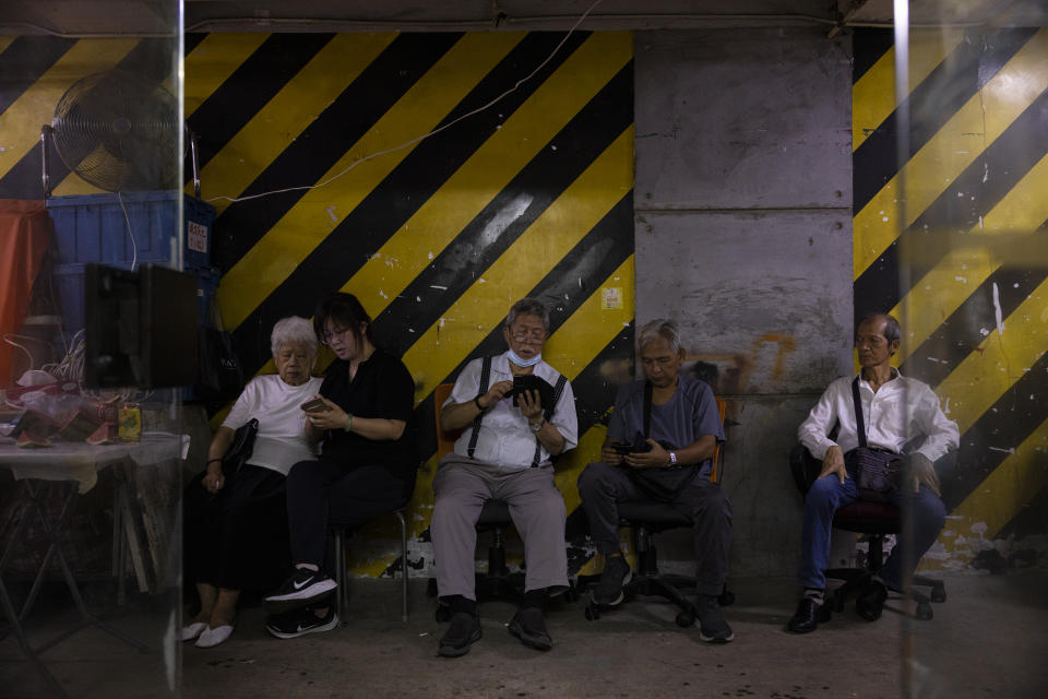 Supporters sit outside Hong Kong's pro-democracy Citizens' Radio station prior to the radio's last broadcast in Hong Kong, Friday, June 30, 2023. (AP Photo/Louise Delmotte)