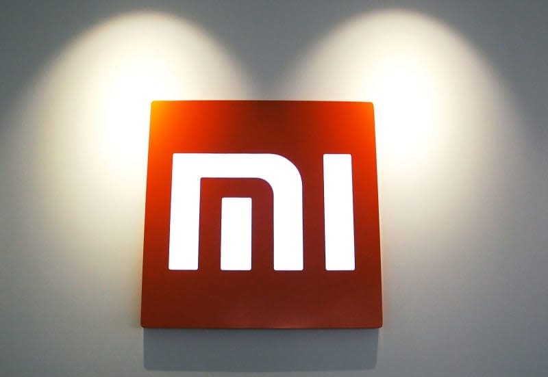 The logo of Chinese smartphone provider Xiaomi hangs on a wall at the company's headquarters. Stephan Scheuer/dpa