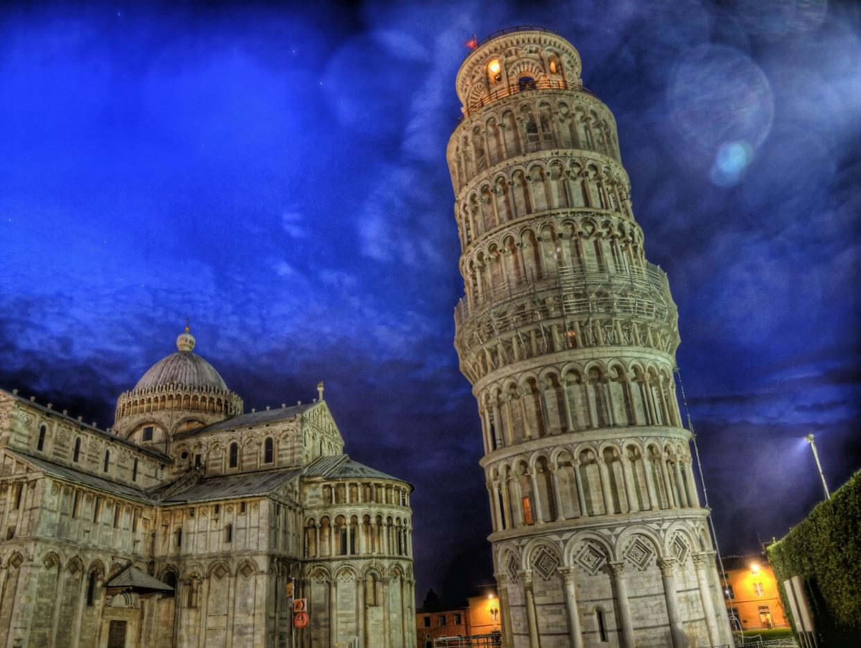 Leaning Tower of Pisa at night. The building on the left is the Cathedral, for which the tower is the bell tower.