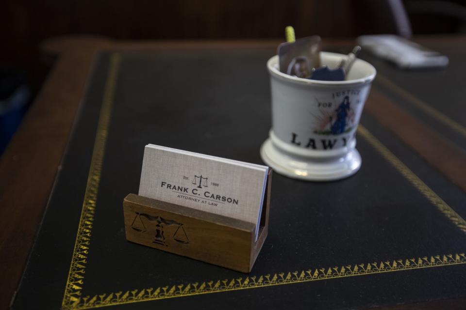 Business cards on Frank Carson's desk.